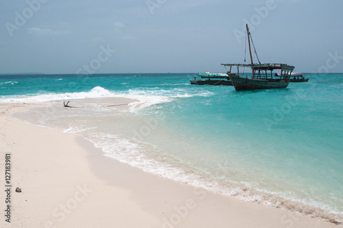 anchored boat by the sandy beach