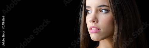 Photos Portrait of beautiful brunette girl with long hair isolated on black background