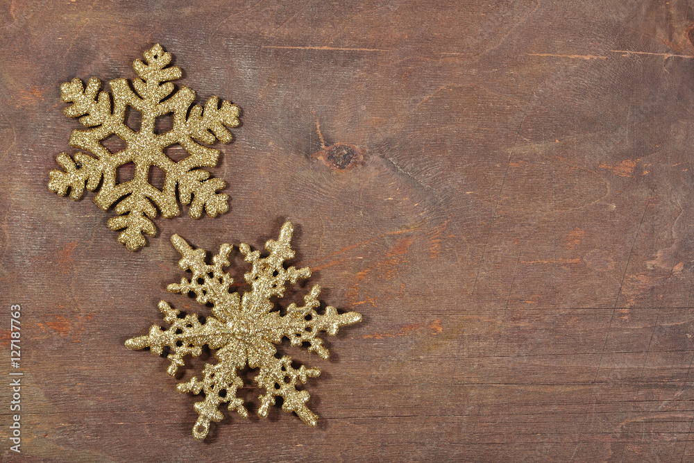 Two snowflakes on a wooden background
