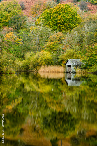 Rydal Boathouse with beautiful Autumn reflections in the Lake District.