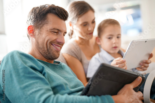 Parents with kid connected on digital tablet