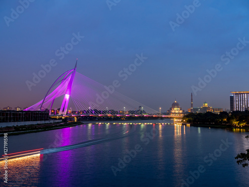 Purple colour lighted Seri Wawasan Bridge with reflection on the water at Putrajaya, Malaysia