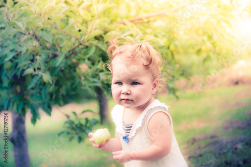 Baby girl under the apple tree