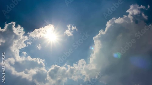 cloudscape with bright sun shining with clouds passing.