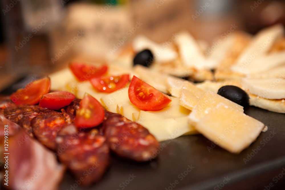 Appetizer with sausage, cheese and tomato