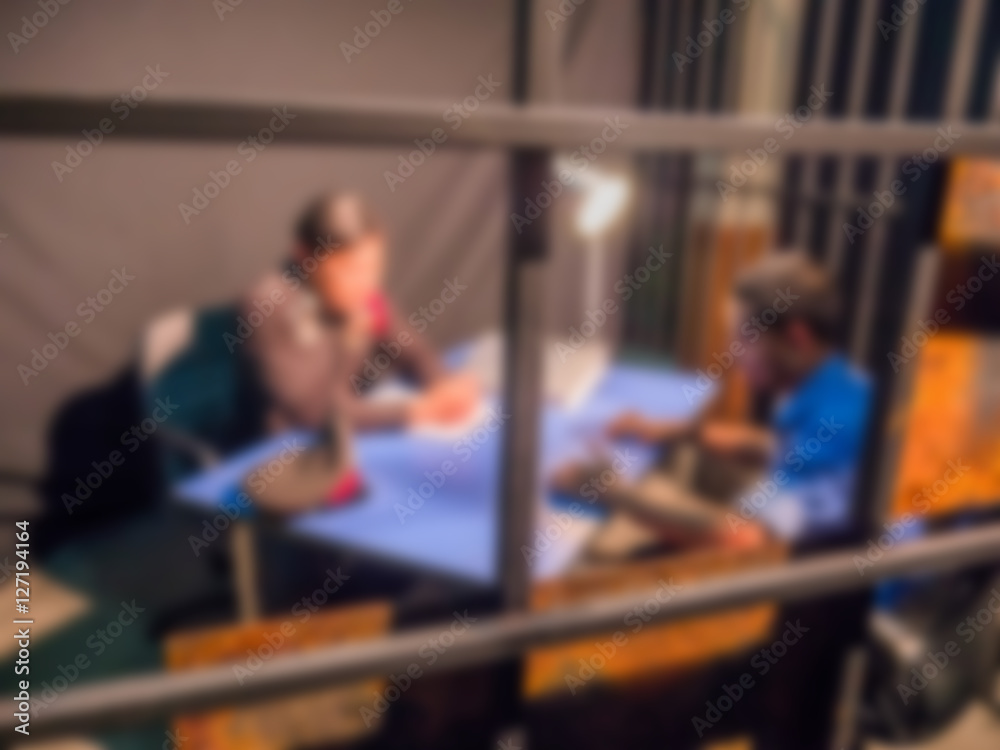 Blurred background Policeman trying to force the suspect man tell the truth Blurred background Policeman trying to force the suspect man tell the truth