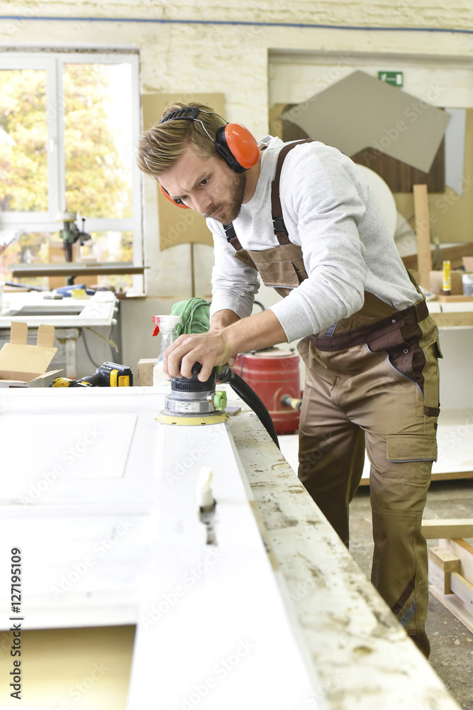 Carpenter restoring a wooden door Carpenter restoring a wooden door