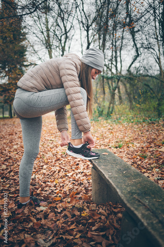 Young woman getting ready for jogging in the park