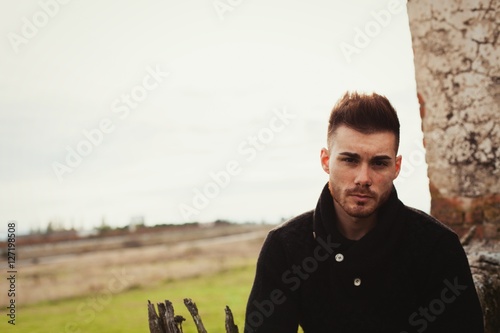 Attractive guy with the field of background