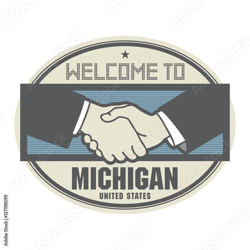 Business concept with handshake and the text Welcome to Michigan