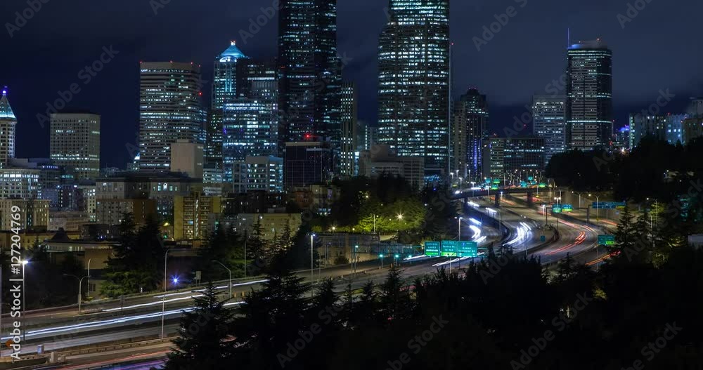 Seattle, Washington, USA - illuminated skyline of Seattle as seen from Dr. Jose Rizal Park with Interstate 5 at night with moving clouds - Timelapse with zoom in Seattle, Washington, USA - illuminated skyline of Seattle as seen from Dr. Jose Rizal Park with Interstate 5 at night with moving clouds - Timelapse with zoom in