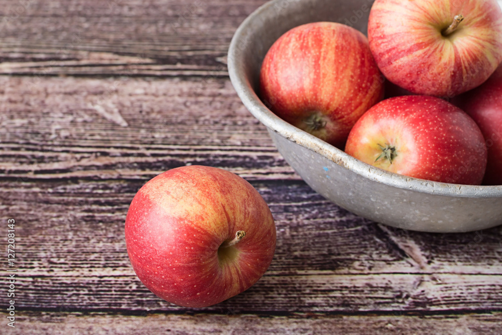 Apples. Red ripe apples in an old aluminum bowl on a wooden table. Apples. Red ripe apples in an old aluminum bowl on a wooden table.