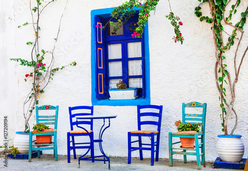 Fototapeta Naklejka Na Ścianę i Meble -  Traditional Greece series - wooden chairs in small street taverna
