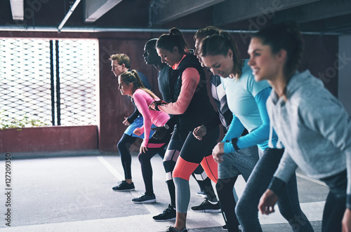 Group of diverse young friends lining up for a run