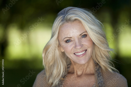 Portrait Of A Mature Woman Smiling At the Camera At The Park