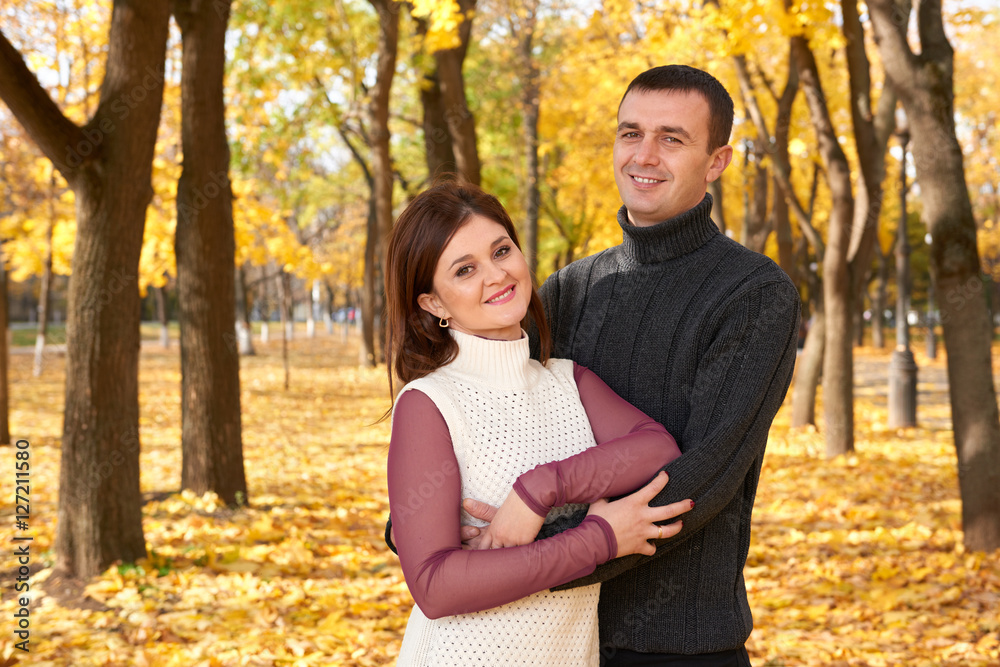romantic people, happy adult couple embrace in autumn city park, trees with yellow leaves, bright sun and happy emotions, tenderness and feelings romantic people, happy adult couple embrace in autumn city park, trees with yellow leaves, bright sun and happy emotions, tenderness and feelings