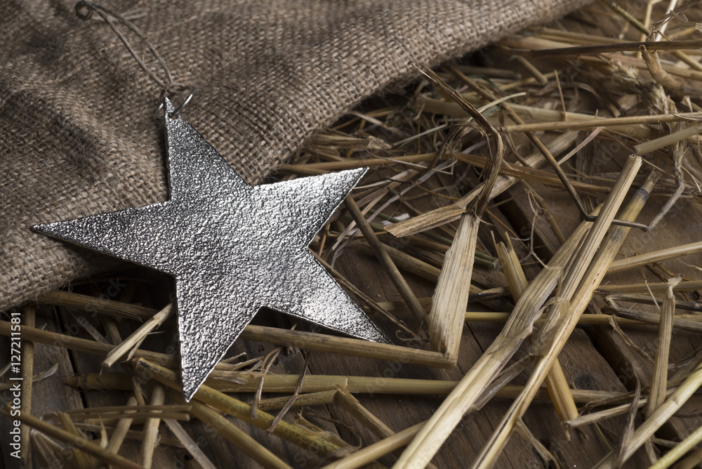 Christmas star on a metal background burlap and hay. Christmas star on a metal background burlap and hay.