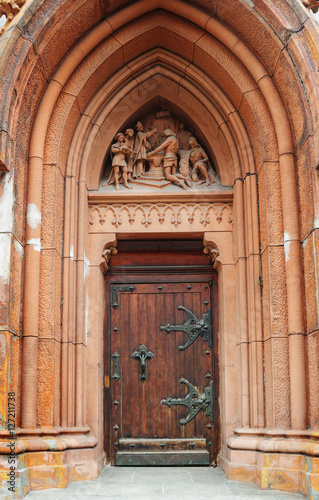 wooden doors with metal hinges and a beautiful arch