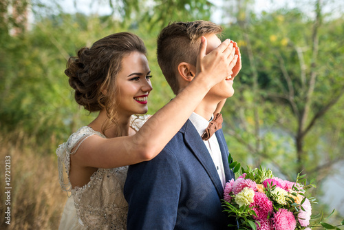 Guess who? The bride and groom in the park, wedding photo shoot. The smiles and cheerful mood