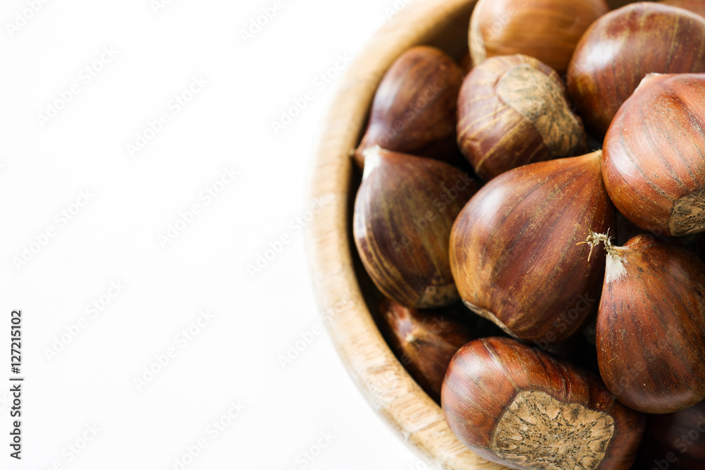 Chestnuts in a bowl isolated on white background
Chestnuts in a bowl isolated on white background