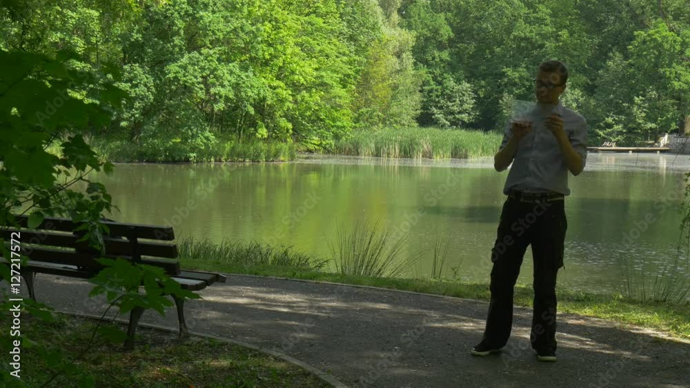 Man Clicks Virtual Tablet in Shadow From Tree Businessman in Park Forex Trading Payment Online Ordering Over Internet Tourist by the Lake Fresh Summer Man Clicks Virtual Tablet in Shadow From Tree Businessman in Park Forex Trading Payment Online Ordering Over Internet Tourist by the Lake Fresh Summer