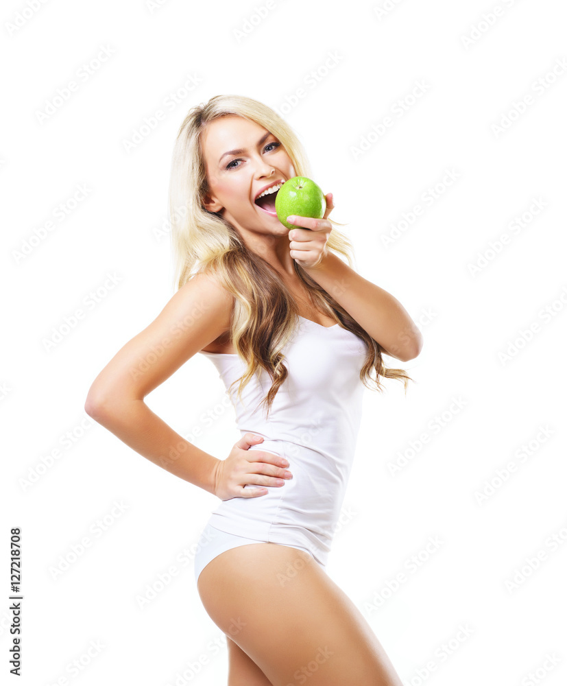 Young and fit woman holding a fresh green apple Young and fit woman holding a fresh green apple