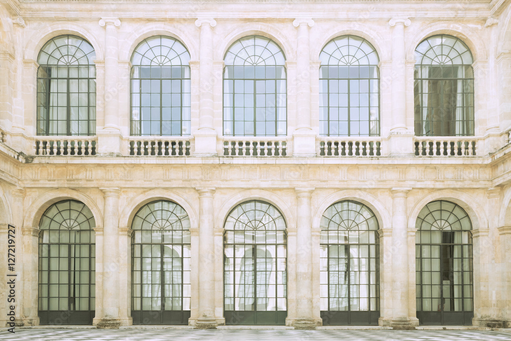 Classic architecture. Close up of a classic style facade with large windows and glass doors