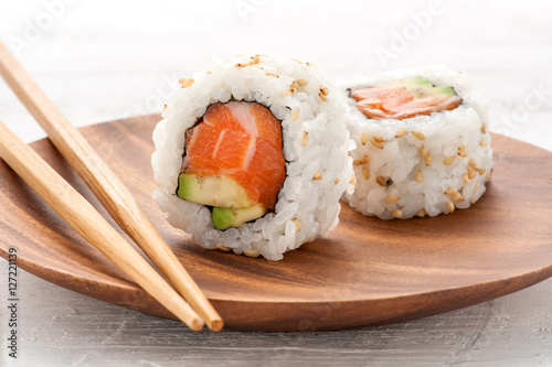 Two fresh salmon and avocado sushi uramaki photo