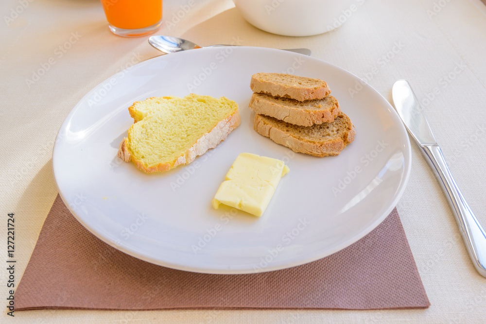 Breakfast including coffe, orange juce, bread, and butter. Breakfast including coffe, orange juce, bread, and butter.