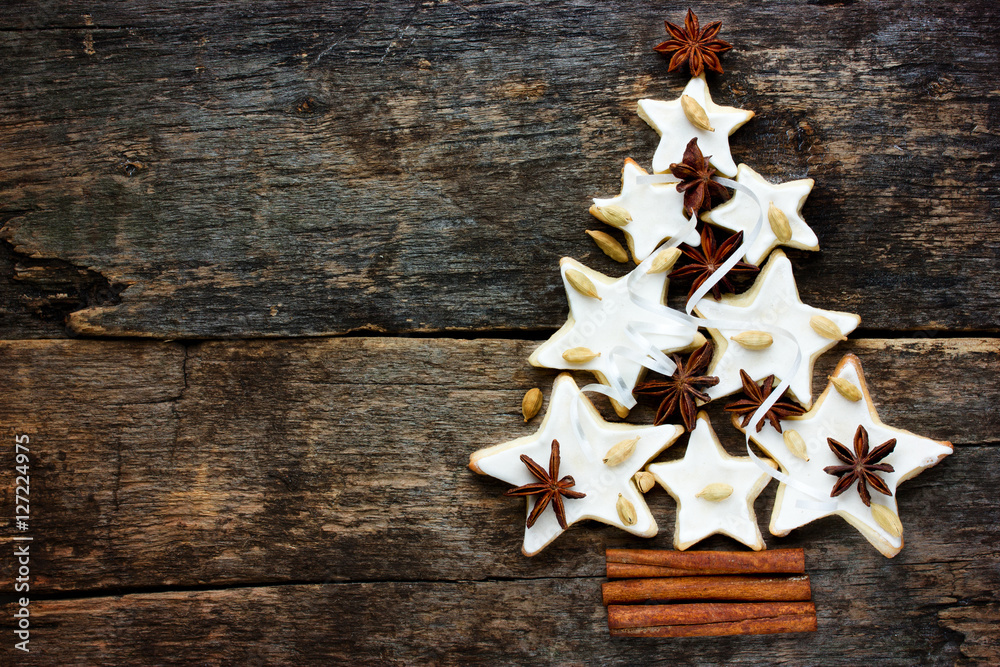 Xmas background: Christmas tree of gingerbread cookies with spices Xmas background: Christmas tree of gingerbread cookies with spices