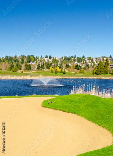 Golf place with gorgeous green and pond.