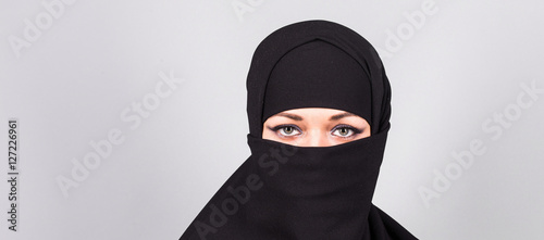 Bild auf Leinwand Young arabian woman in hijab or niqab.