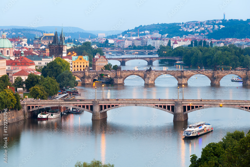 Fototapeta premium Panorama of the old part of Prague from the Letna park at dusk. Beautiful view on the bridges over the river Vltava at sunset. Old Town architecture, Czech Republic.