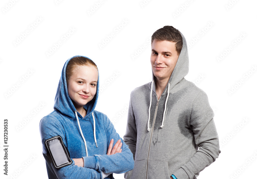 Teenage boy and girl in sweatshirts. Studio shot, isolated. Teenage boy and girl in sweatshirts. Studio shot, isolated.