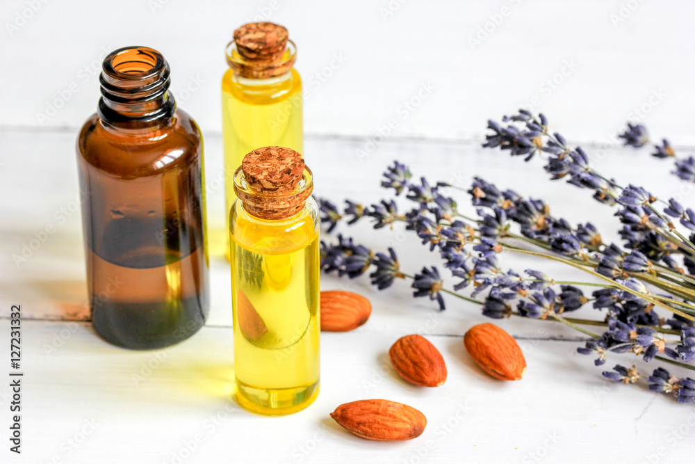 avocado oil for handmade cosmetics with herb on wooden background avocado oil for handmade cosmetics with herb on wooden background