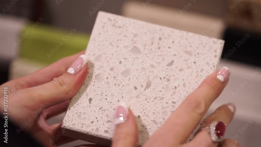 samples of granite material for the manufacture of countertops and sinks. choice and offer granite in female hands samples of granite material for the manufacture of countertops and sinks. choice and offer granite in female hands