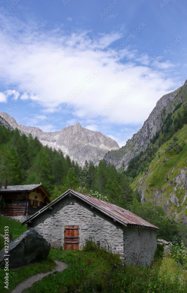 a Stone Mountain hut in a narrow valley in the Swiss Alps