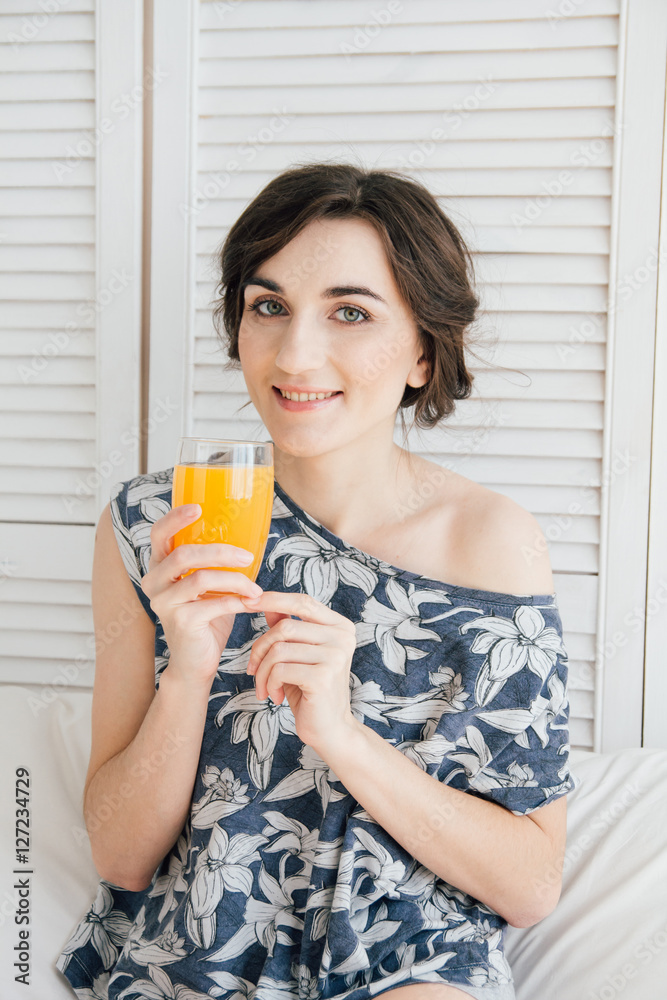 Girl drinking orange juice at Breakfast in bed Girl drinking orange juice at Breakfast in bed