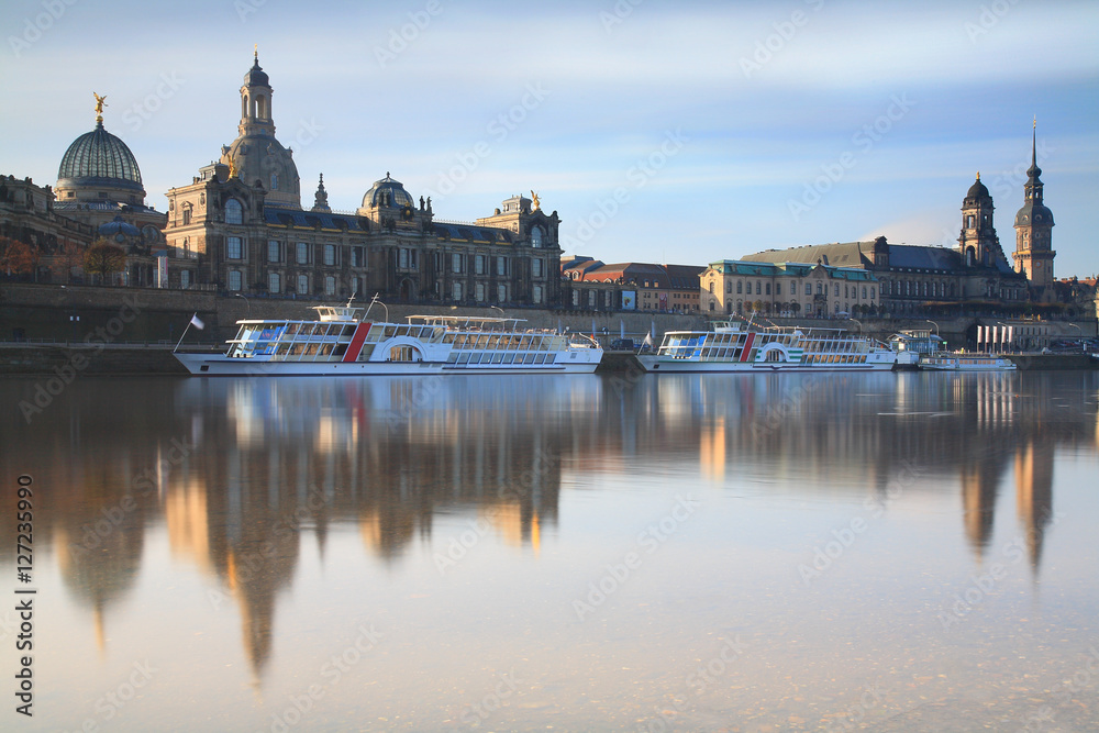 Skyline of Dresden with Elbe river, passenger ships and in background the Frauenkirche at sunrise