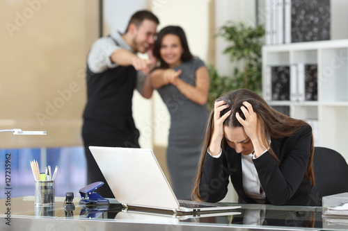Businesspeople bullying a colleague at office photo