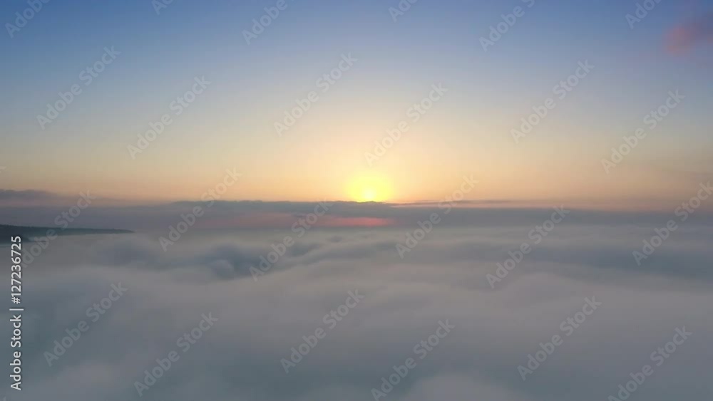 Sunrise above the clouds, aerial view over the skyline Sunrise above the clouds, aerial view over the skyline