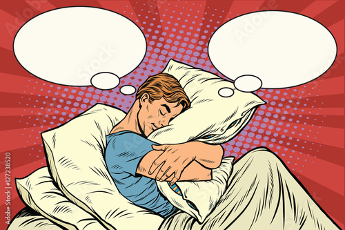Dreamer man in bed hugging a pillow