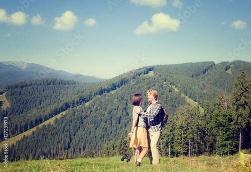Happy beautiful couple on the green grass meadow © Nickolay Khoroshkov