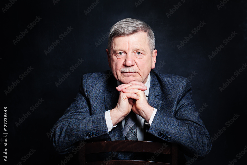 Confident Mature Businessman in a Suit. Senior Man on Black Back Confident Mature Businessman in a Suit. Senior Man on Black Back