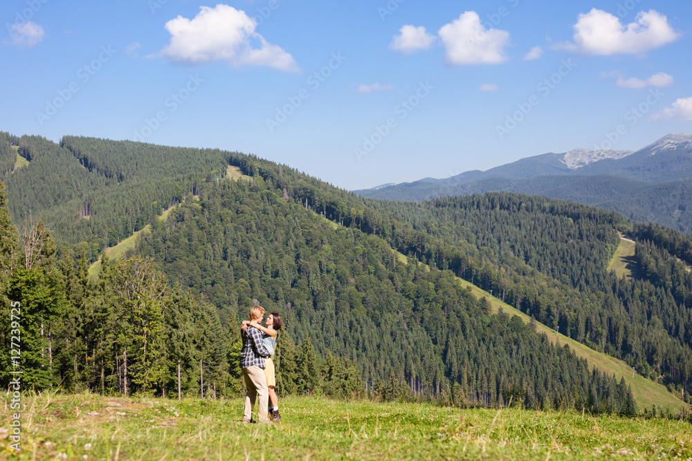 Happy beautiful couple on the green grass meadow Happy beautiful couple on the green grass meadow