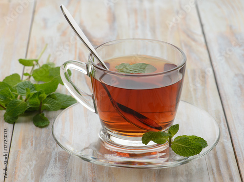 Tea with mint on wooden background
