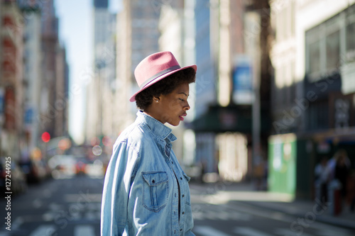 Young fashionable African American woman crossing the street © goofyfoottaka
