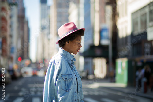 Young fashionable African American woman crossing the street