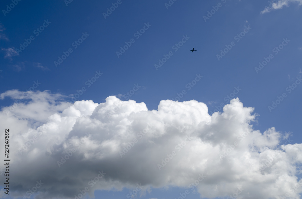 Sunny blue sky and clouds and airplane