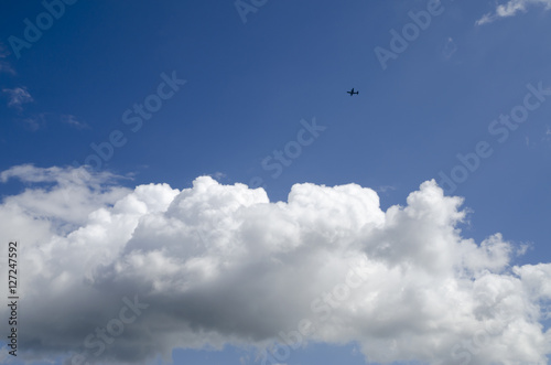 Sunny blue sky and clouds and airplane